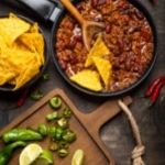 Chilli Con Carne recipe. Chilli con carne in a pan with tortilla chips on the side