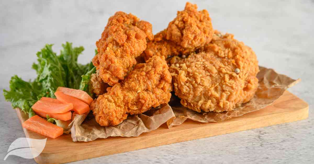 4 pieces of gluten free fried chicken on a wooden board