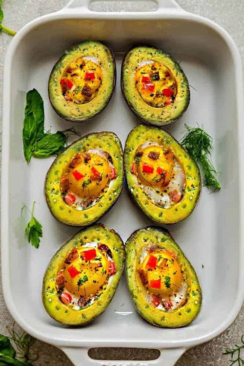 Low carb breakfast recipes Avocado Egg Boats baked with crispy bacon and bell peppers