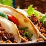 close up view of three mexican tacos