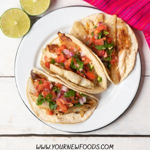 3 mexican fish tacos on a white plate