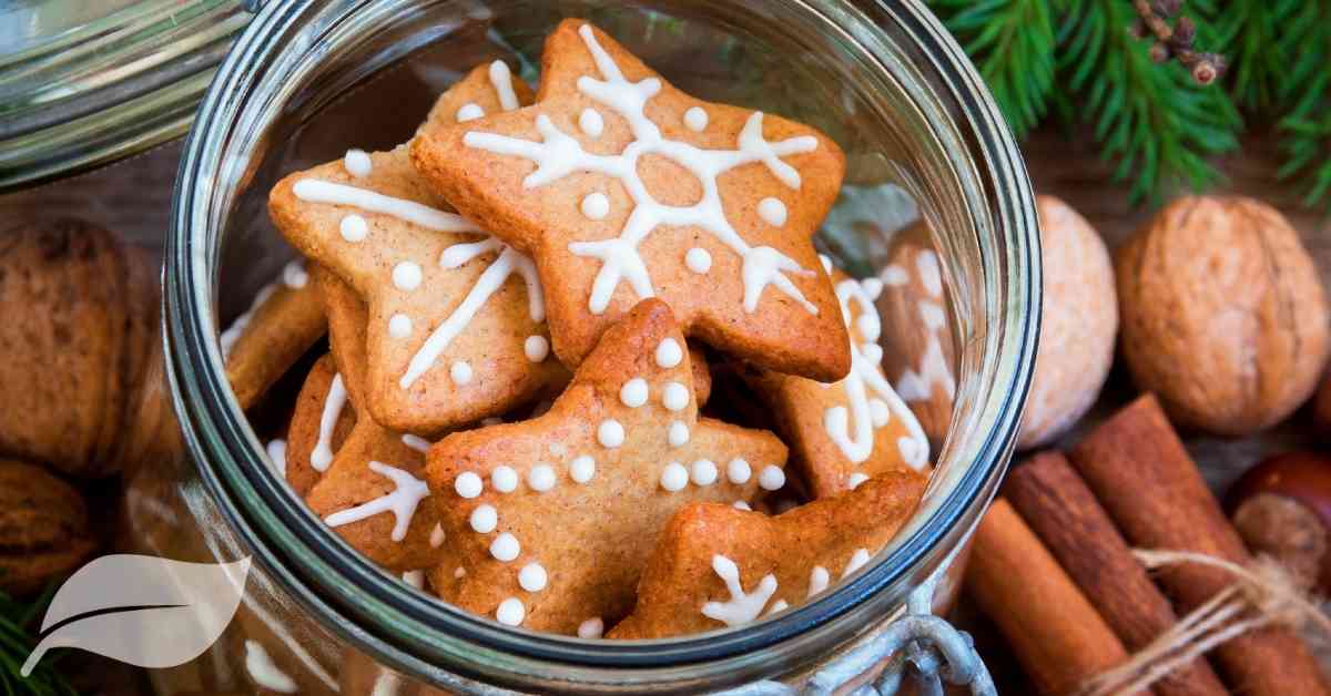 star shaped cookies with white festive frosting in a glass jar