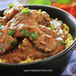 lamb curry in a black dish