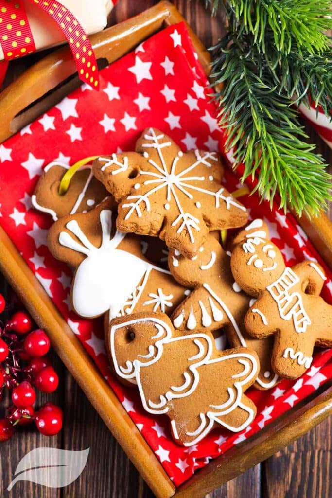 Gluten-Free Christmas Cookies with white frosting on a red background
