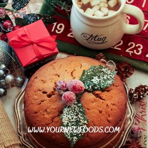 traditional christmas cake with two holly leaves and berries on top as a decoration