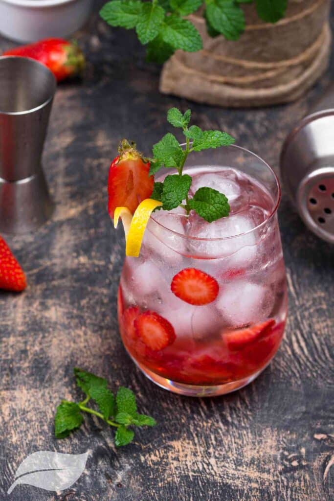 Strawberry cocktail in a glass with slices of strawberry and ice cubes