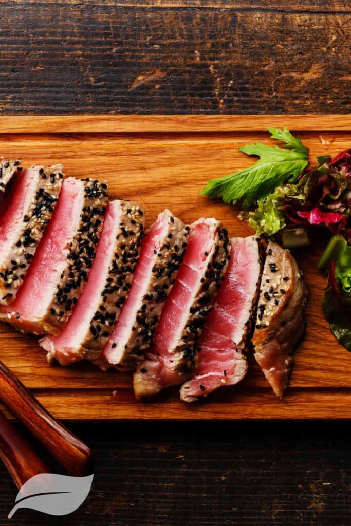 sliced tuna steak on a wooden board