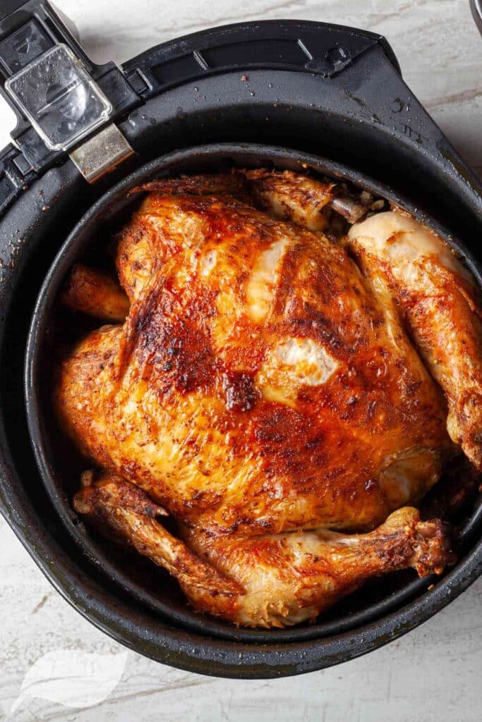 roasted whole chicken in an air fryer basket