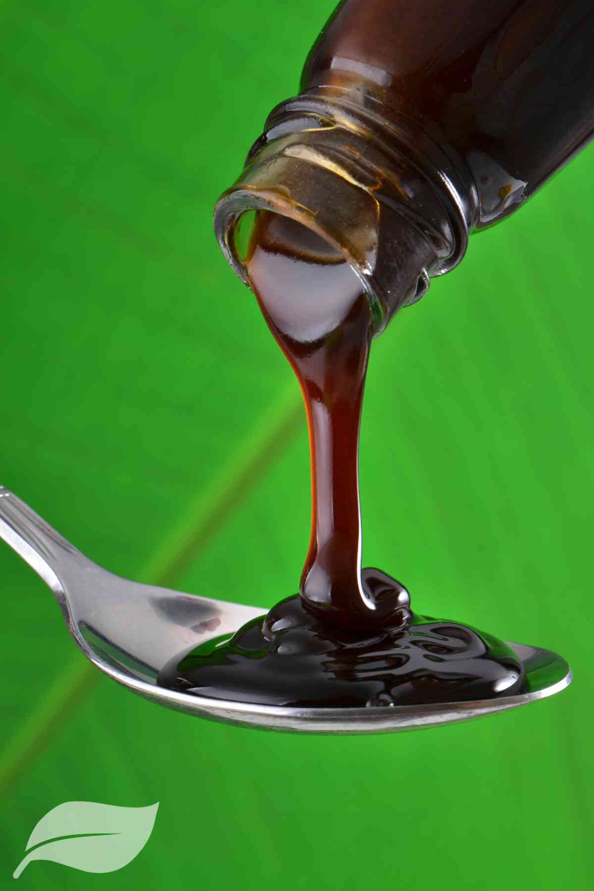 Asian oyster sauce being poured onto a spoon